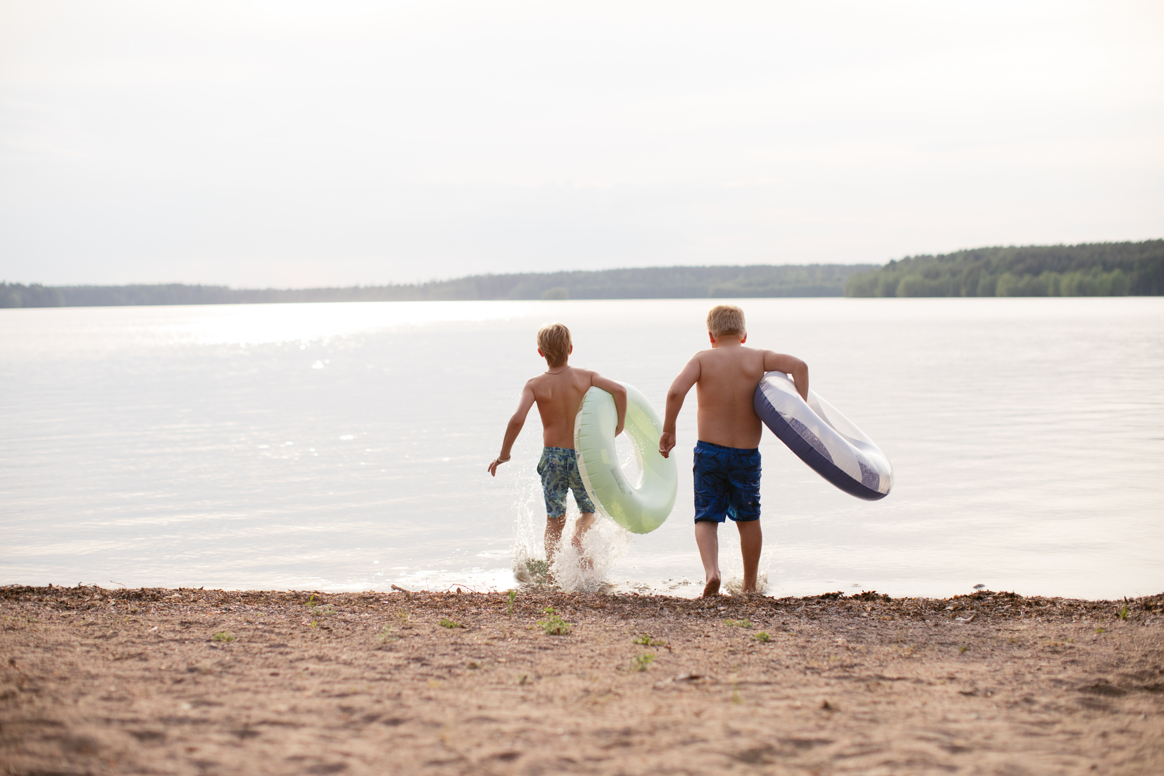 The sandy lake shore used for swimming and water games at the camp